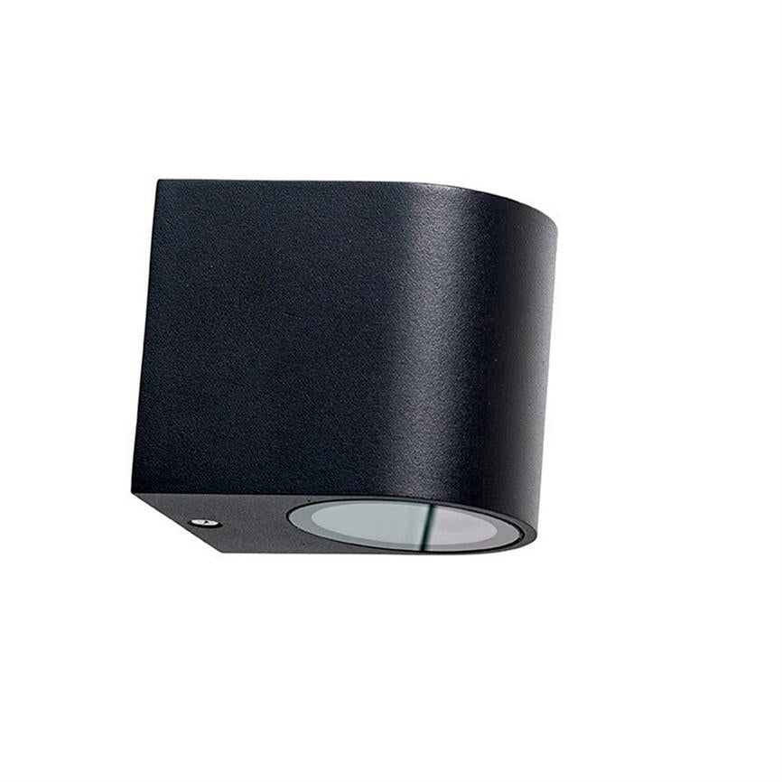 Black cube-shaped wall lamp with rounded side; round glass opening at the bottom, facing downwards; depicted against a white background.