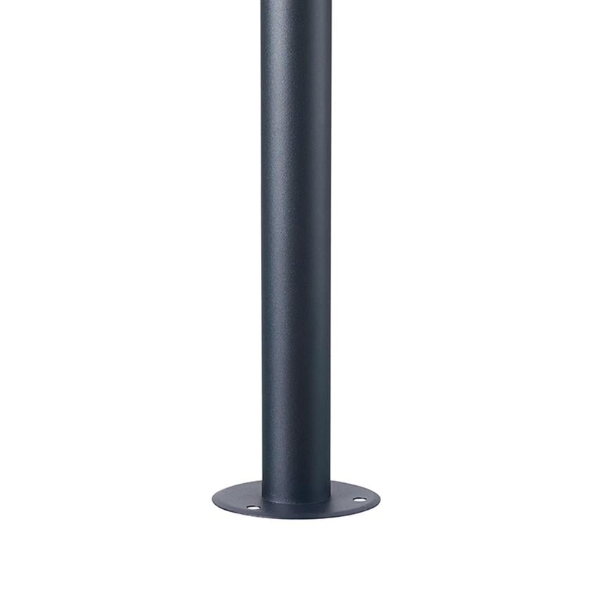 A dark gray metal pole stands vertically on a round, flat base plate with three screw holes, surrounded by a uniform white background.