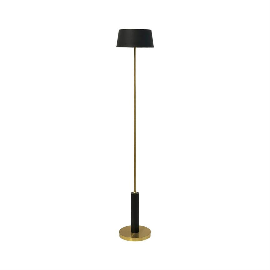 Floor lamp standing upright: slim, brass-colored rod with black cylindrical center section and round brass base; small black lampshade at top; isolated against white background.