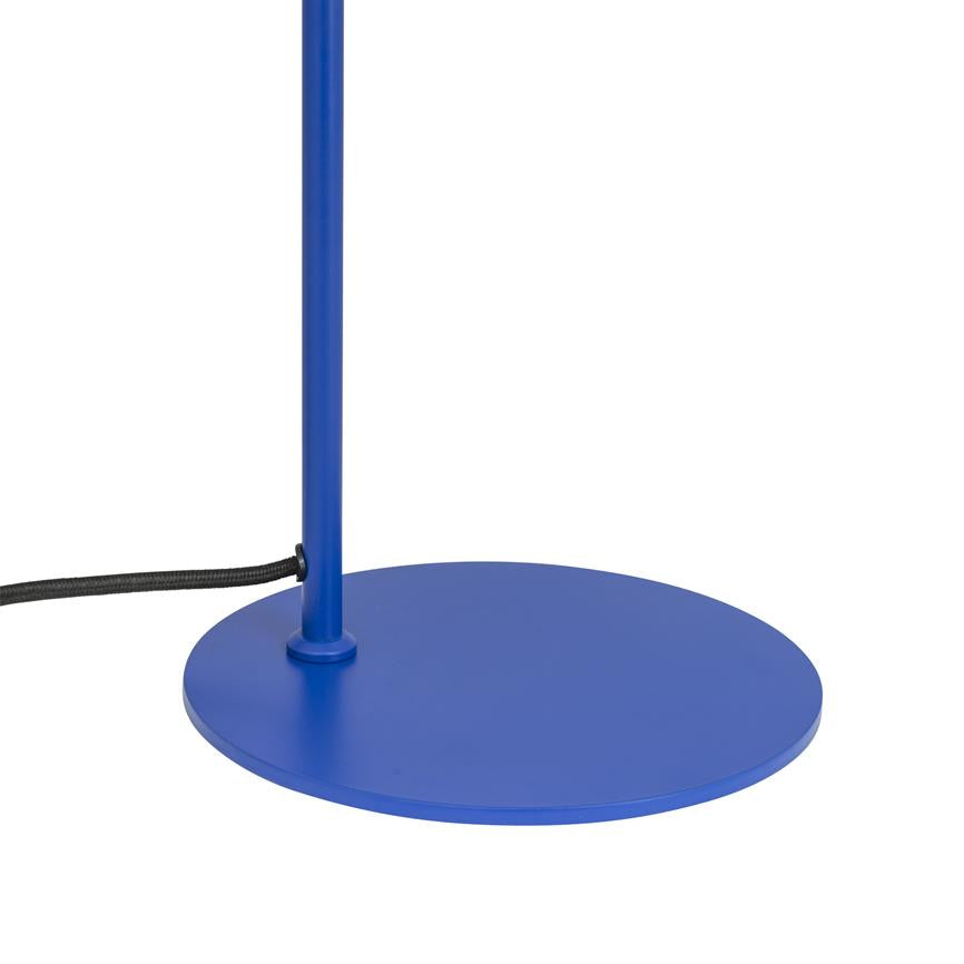Blue lamp base stands vertically on a flat, round base plate; a black cloth-covered wire runs from the side of the pole to the left on a white background.