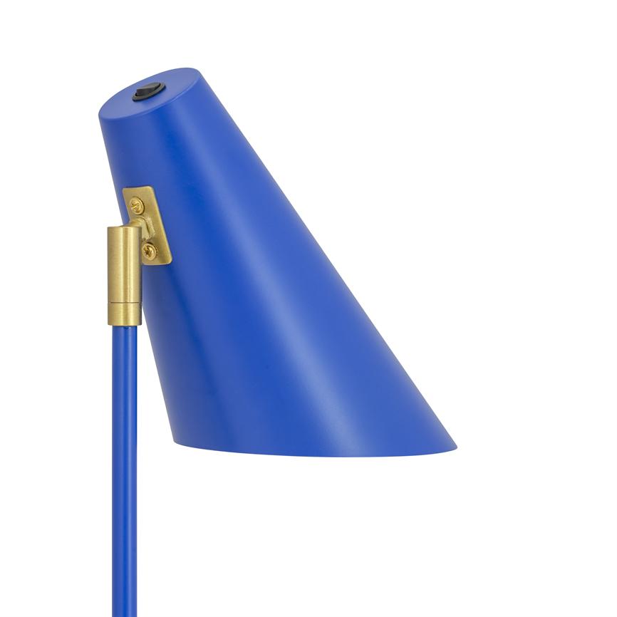Blue metal lampshade sits angled downwards on a slim blue stand, attached with a brass hinge; simple matte finish against a neutral white background.