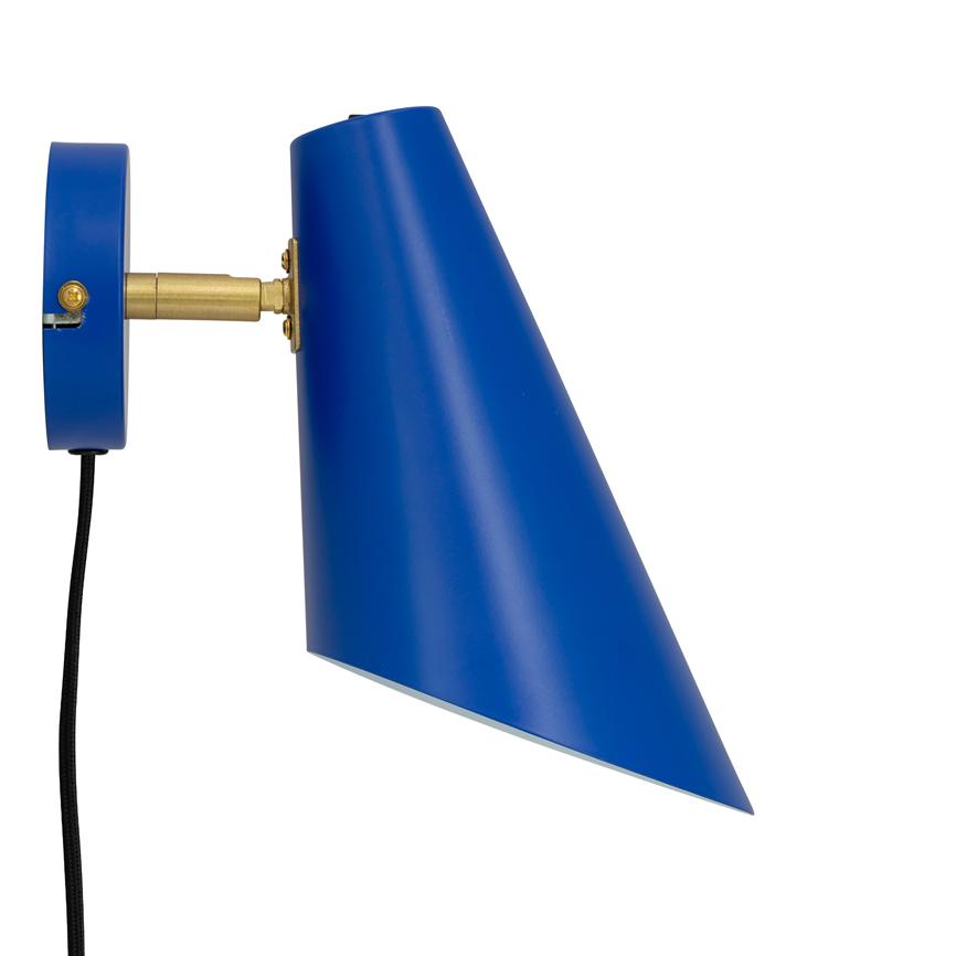 Blue wall lamp points obliquely downwards; mounted to wall with brass joint and black fabric cord on uniform white background.