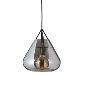 A smoky glass pendant hangs from a black fabric cord; inside the pendant is a visible light bulb with copper colored filaments. The pendulum is held by three black struts, on a white background.