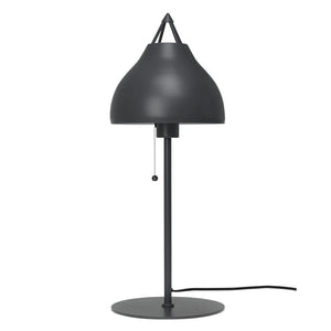 Table lamp with dark gray rounded shade hangs over a vertical rod, operated via pull button; placed on round base with visible cord, against neutral white background.