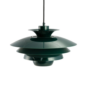 A dark green, multi-layered pendant light hangs from a black cord above a neutral white background; wide, concentric layered metal shades distribute the light downwards.