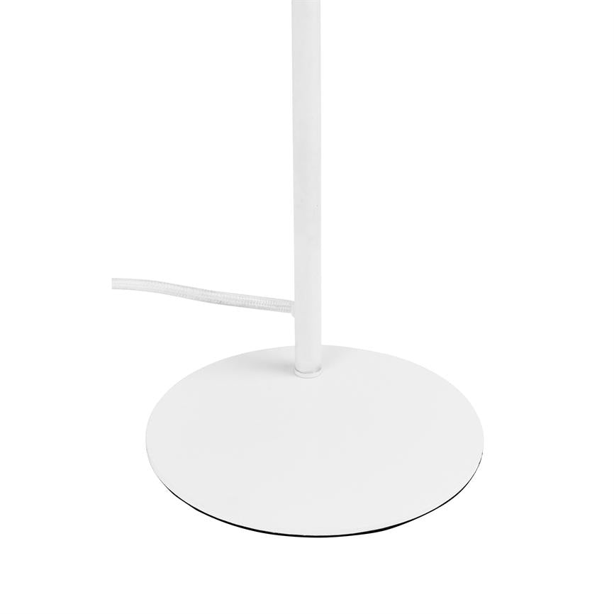 The round white base of the lamp stands stable and carries a vertical white rod; a white cloth-covered cord runs to the left on a uniform white background.
