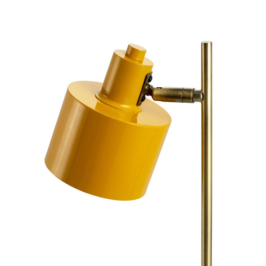 Yellow, cylindrical lamp head is tilted downwards, mounted in a small hinged bracket on a vertical, brass-colored rod in front of a white background.