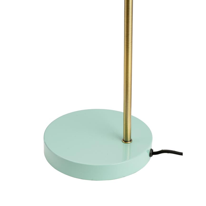 Disc-shaped mint green lamp base supports a slender, vertical brass rod; black textile cord is led out from the side. White, neutral background.