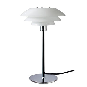 Table lamp with three white, bowl-shaped shades on a chrome rod and round chrome base stands centrally against a white background; black power cable runs from the foot.