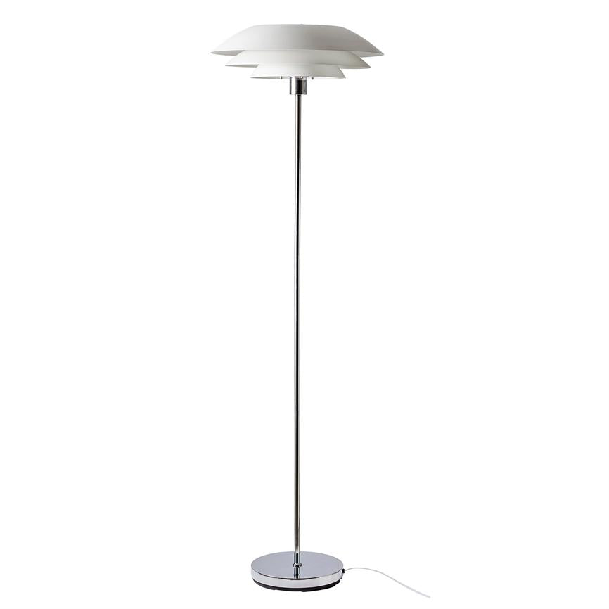 Floor lamp with layered white shades stands upright; it emits soft, downward light; slim chrome bar and round chrome base with white wire against plain white background.