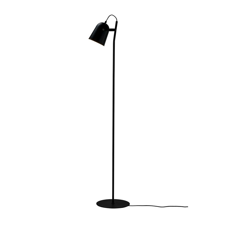 Black floor lamp stands upright, with shade directed downwards, on a round base; black wire extends over a uniform white background.