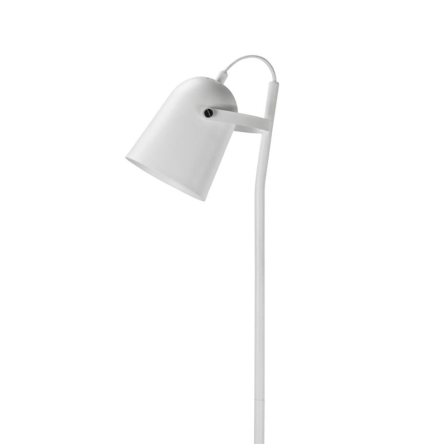 A white floor lamp tilts its adjustable shade downwards; a slim, slightly curved rod and visible cable characterize the modern shape against a neutral white background.