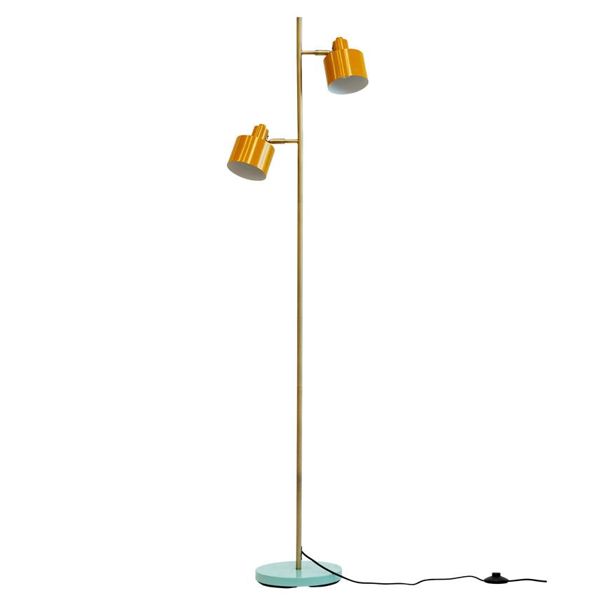 Yellow floor lamp with two adjustable shades mounted on a slender brass rod; stands on a turquoise round foot, black cord and foot switch are on a white background.