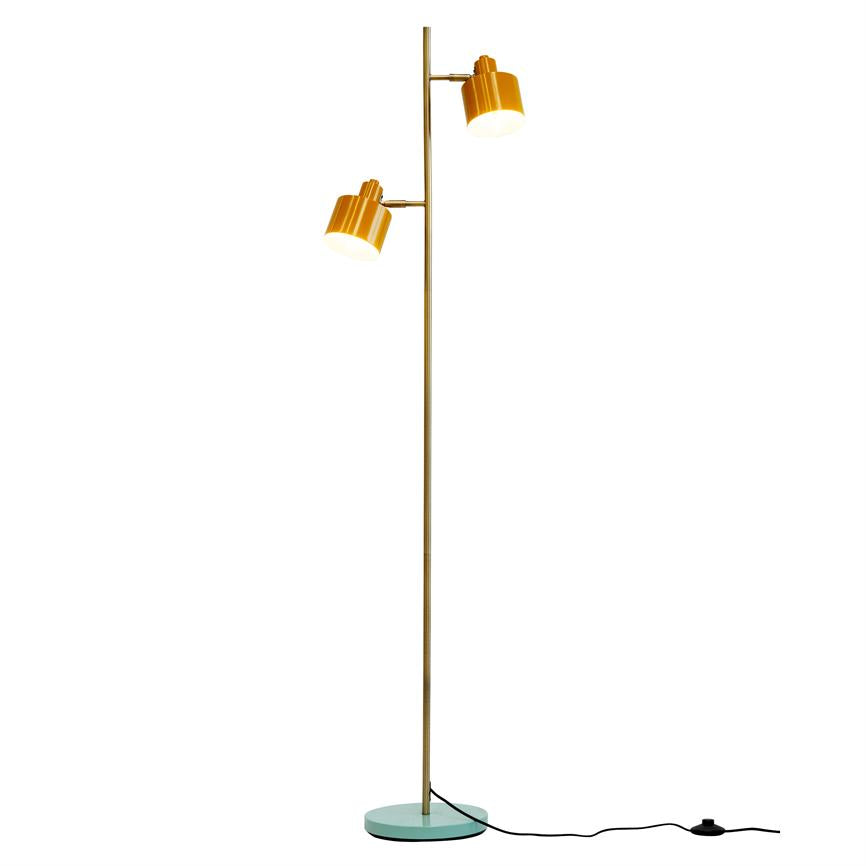 Yellow floor lamp with two adjustable shades that cast light downwards, mounted on thin brass rod and round light blue base, with visible black cord on white background.