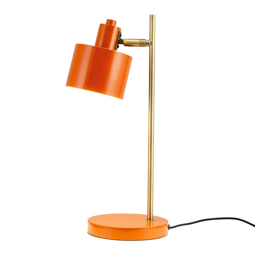 An orange desk lamp tilts its cylindrical shade downwards; thin brass rod connects screen and round base, black wire lies at the base on a neutral white background.
