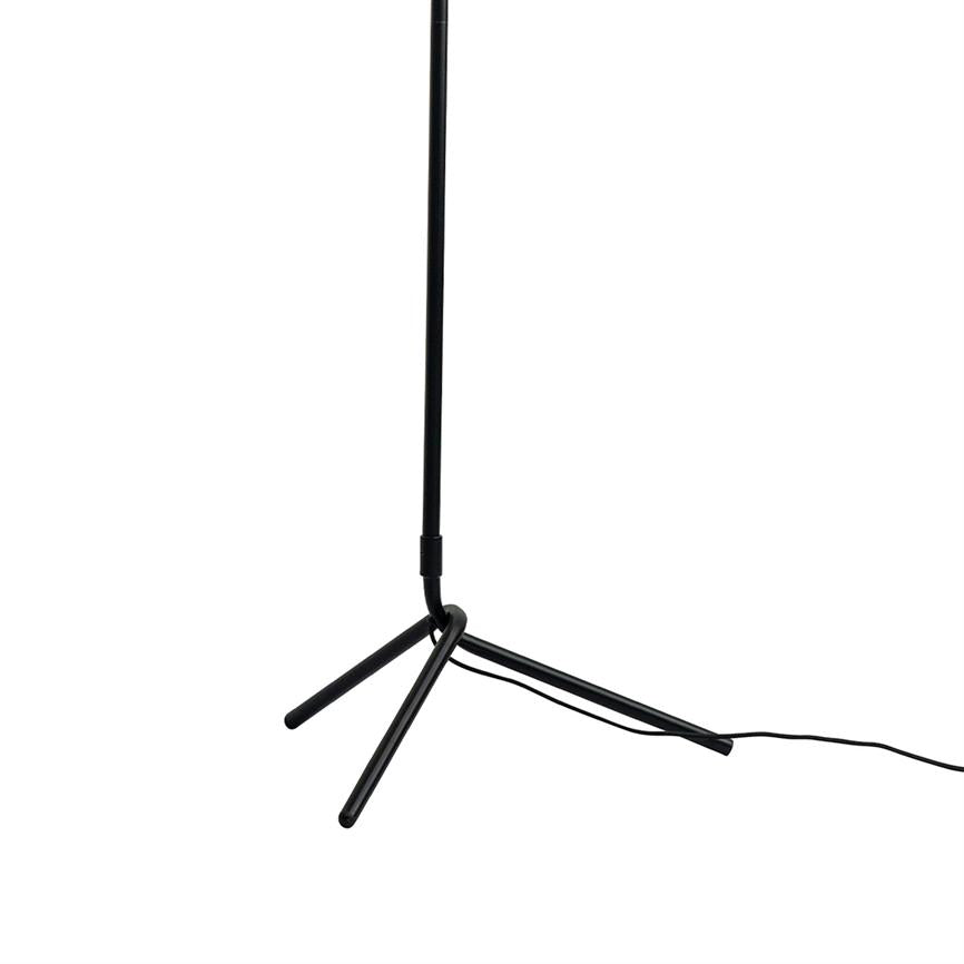 Black slim floor lamp stands on a three-legged base; a loose wire lies along the floor to the right; neutral white background.