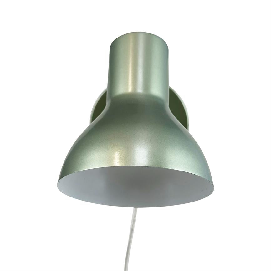 Wall lamp, mounted on wall, with metallic green dome, facing downwards; white wire hangs vertically; simple white background with no other objects.