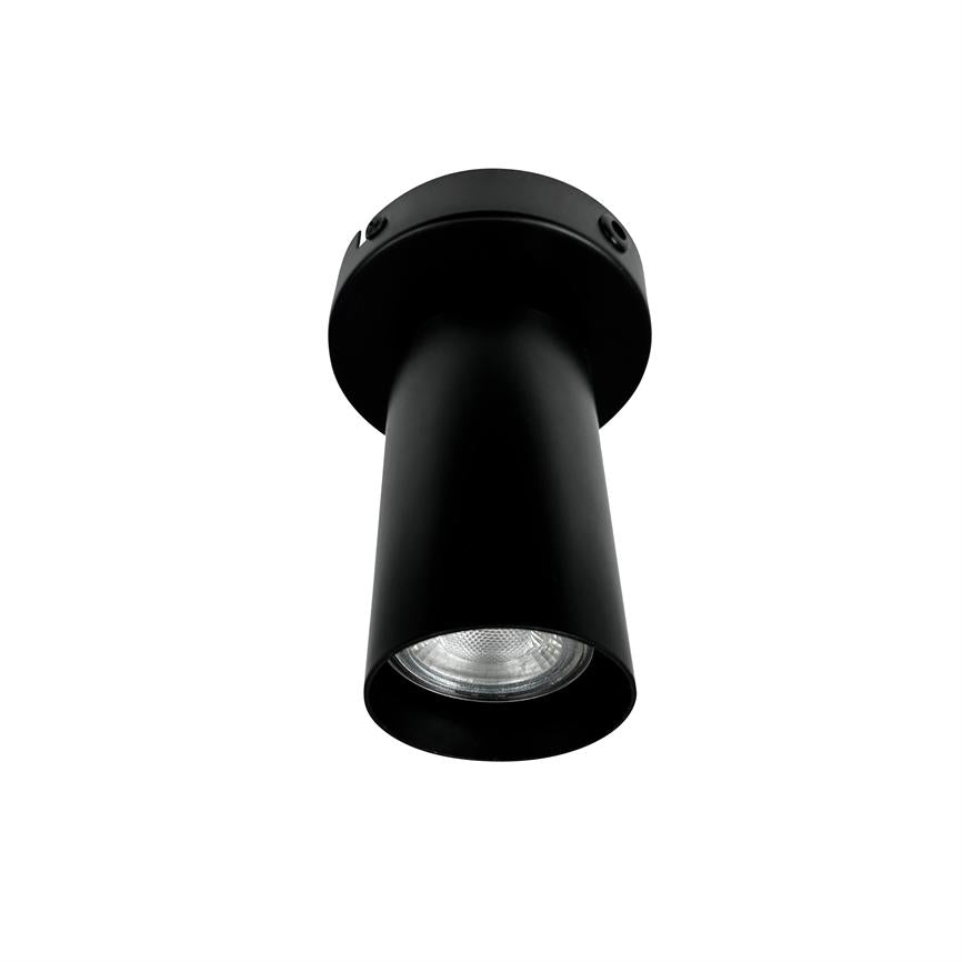 Black cylindrical ceiling spotlight points downwards, with visible reflector eye inside and matt black surface, set against a pure white background.