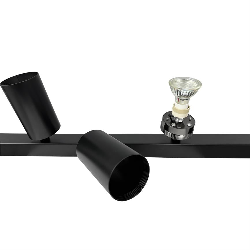 Black track spot: two cylindrical lampshades with one lamp head removed and an exposed GU10 bulb in socket; mounted on a black metal rail against a white background.