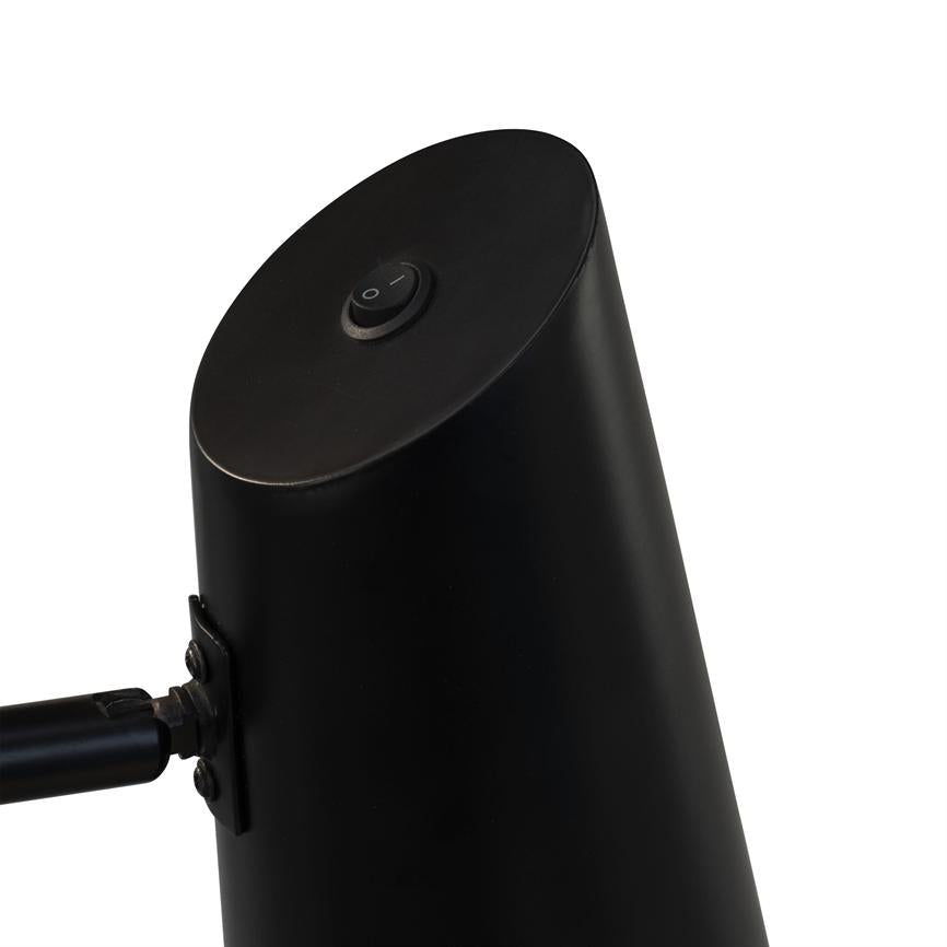 Black lamp head shows a round on/off button marked "O |", attached to arm via hinge; close-up against neutral white background.