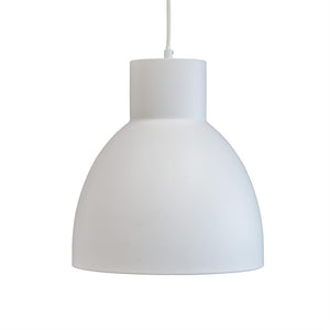 White pendant lamp hangs by a thin white cord above a uniform white background; simple, matte surface with a cylindrical top and a large, round bell-shaped shade.