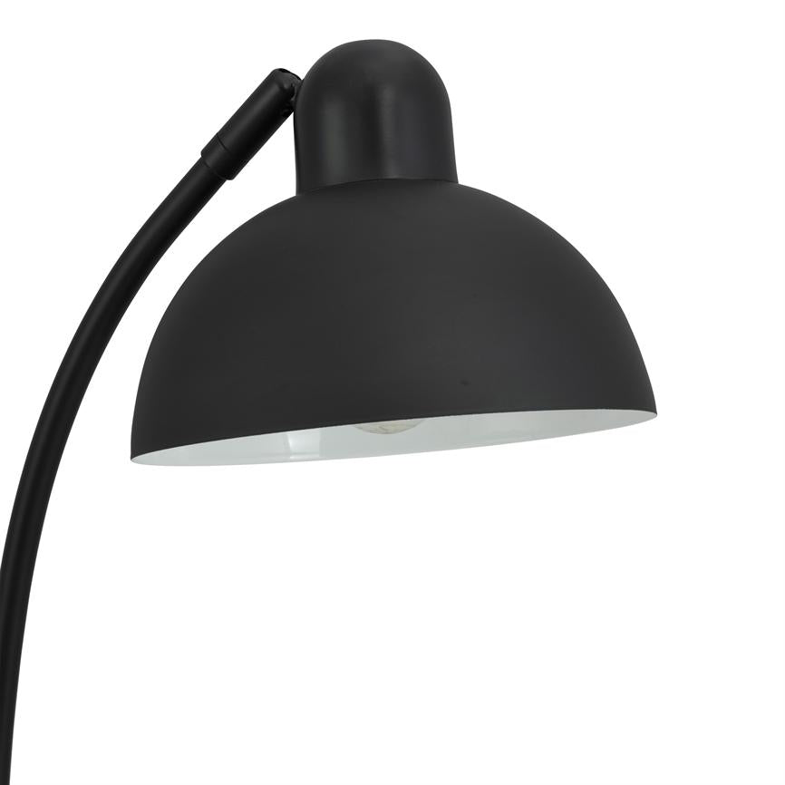 Black lamp with round, bowl-shaped shade, pointing downwards and showing the bulb inside; curved arm in metal; minimalist design against neutral white background.