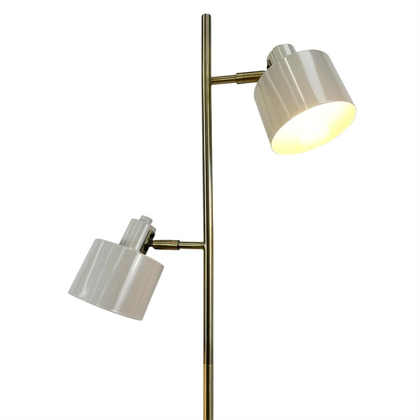 A floor lamp with two white, adjustable shades mounted on a slender brass rod; the top screen is dimly lit, the bottom is angled downwards on a neutral white background.