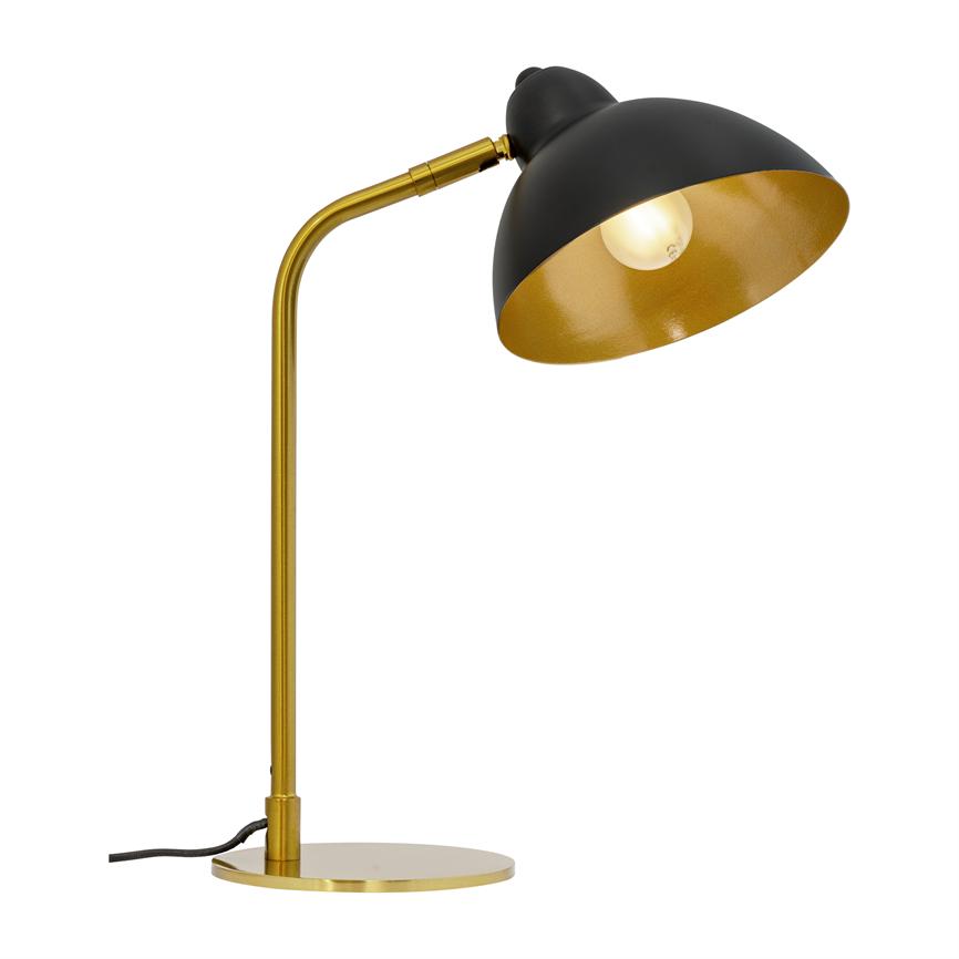 Table lamp with black dome shade and golden interior, light bulb lit, slim golden stand with round base stands on a uniform white background.