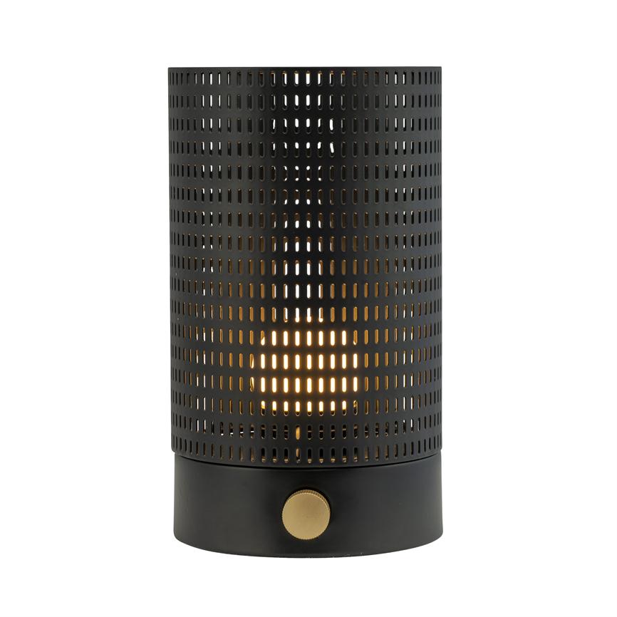 Cylindrical perforated table lamp in black metal with golden knob, emits warm, dot-like light through rectangular holes; placed isolated against white background.