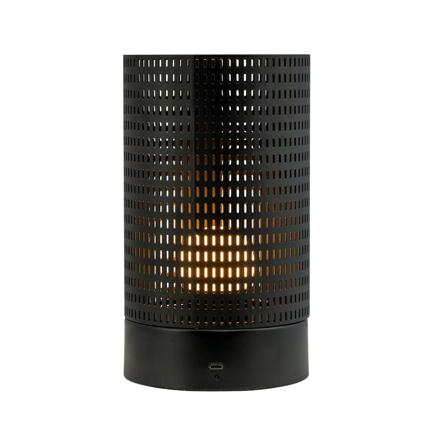 Cylindrical black metal table lamp emits warm, golden light through rows of elongated perforations; it stands on a uniform white background.