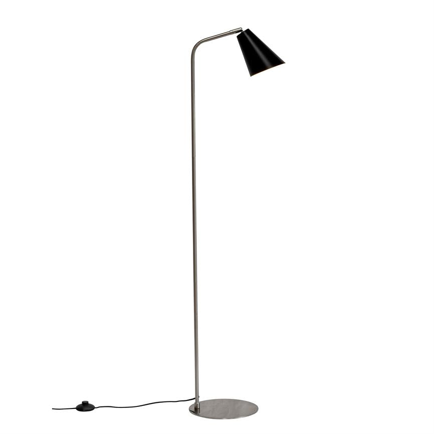 Floor lamp with slim chrome rod and black, sloping shade pointing downwards; stands on a round metal base with visible cord and foot switch against a uniform white background.