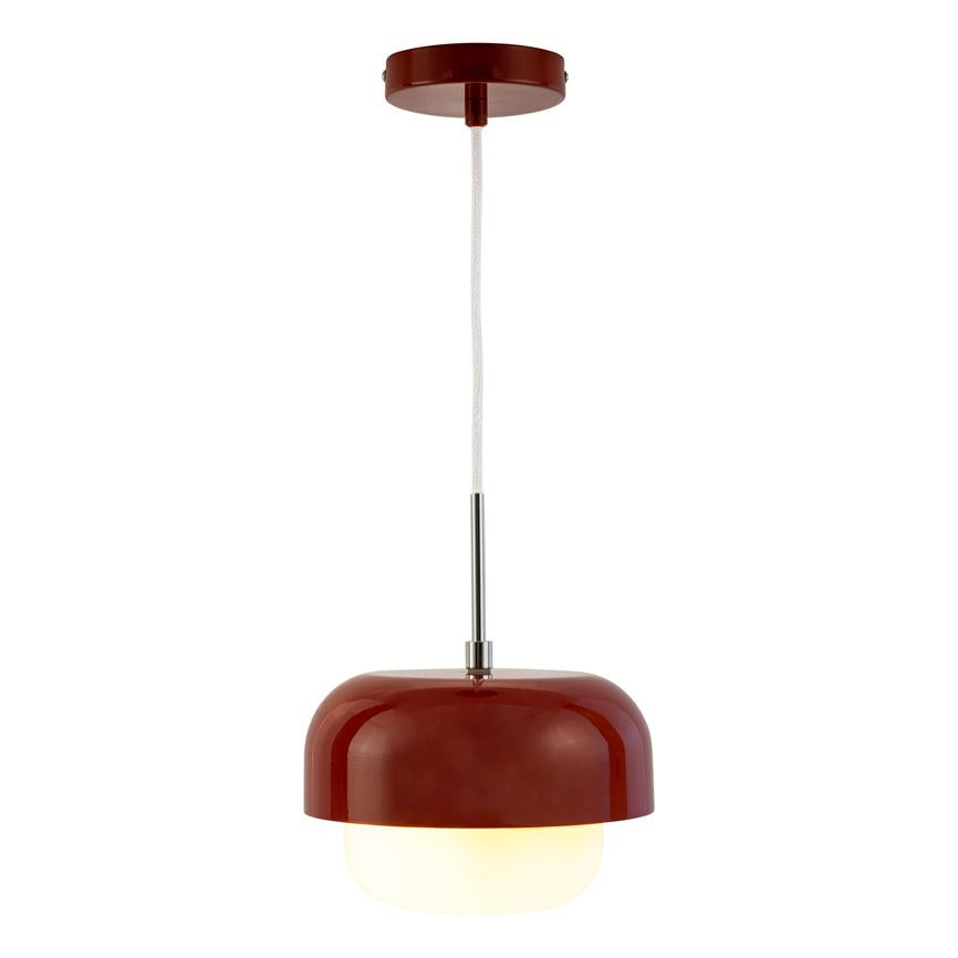 Red glistening pendant lamp hangs by white fabric cord from round ceiling bracket; chrome rod connects the hemispherical metal dome to the matte white diffuser, which emits warm, diffused light against a white background.