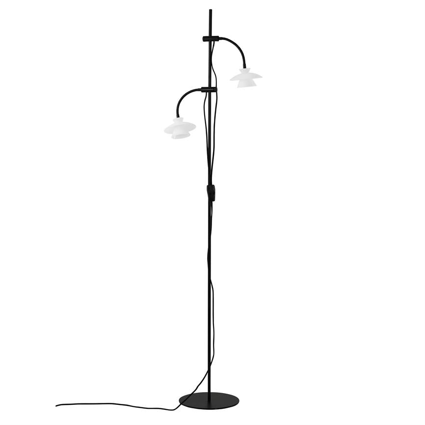 Floor lamp with slender black rod, two curved arms carrying white shades; wire runs down the pole to round black foot on white background.