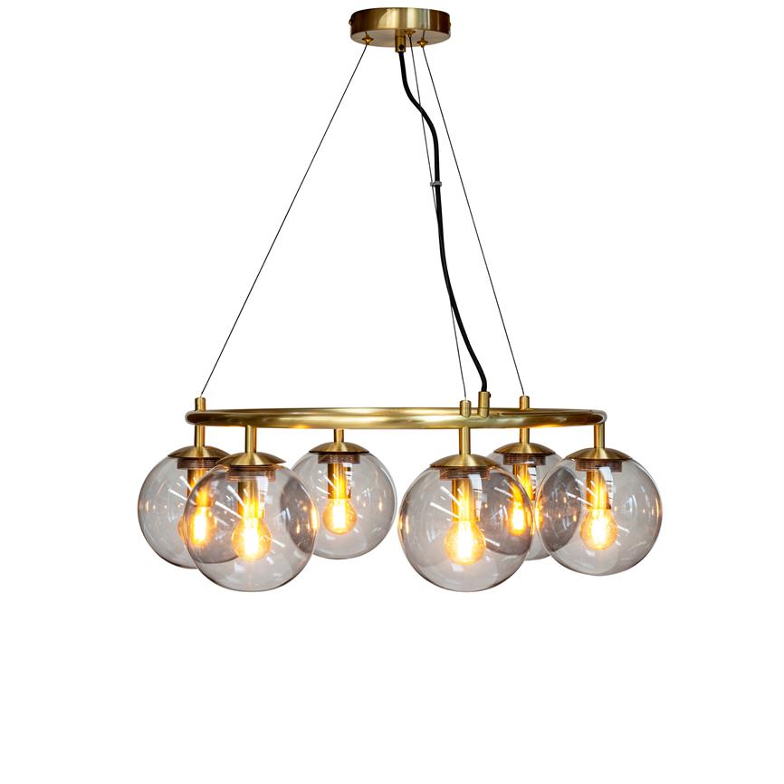A golden ceiling lamp with six clear glass domes, suspended by black cables from a brass ring, which emits a warm golden glow against a neutral white background.