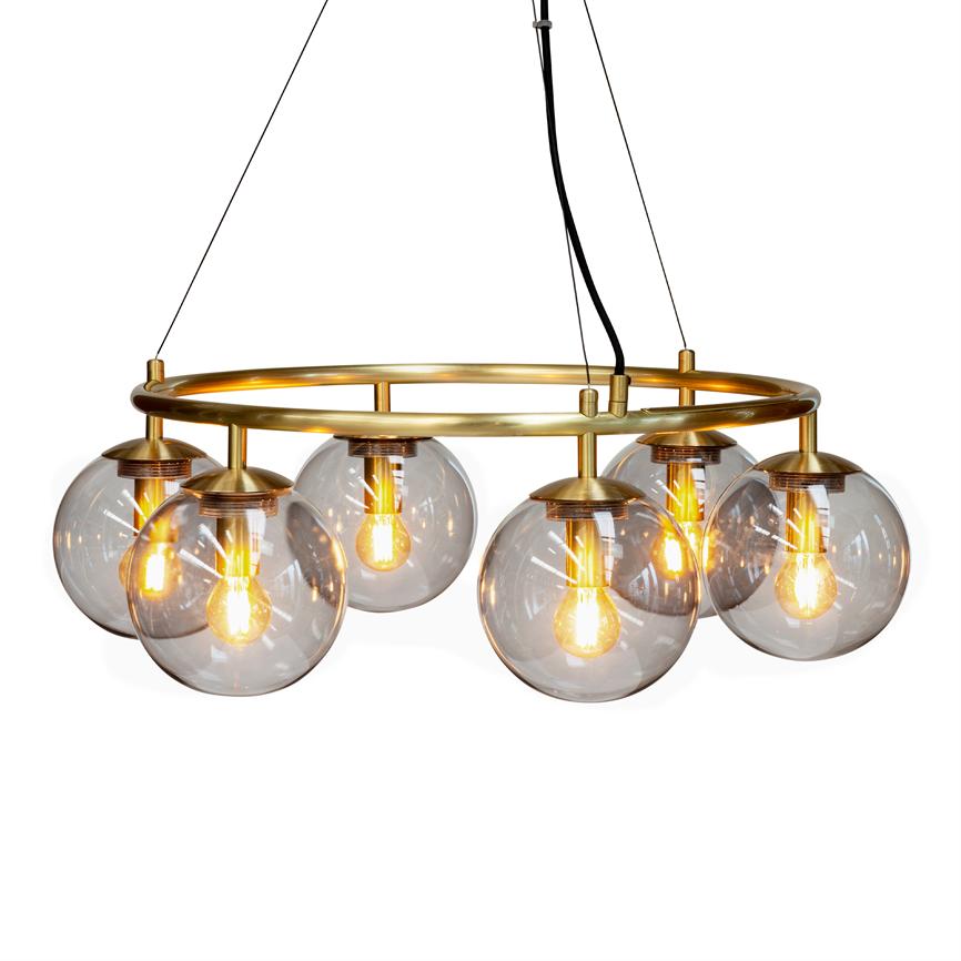 A ring-shaped ceiling lamp with six smoky glass balls on a gold metal frame, illuminated by visible filament bulbs, hangs from thin black wires over a white background.