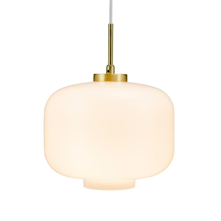 A round, opal white pendant lamp hangs from a fabric cable; it emits soft, warm light from a frosted glass dome with brass fittings against a neutral white background.