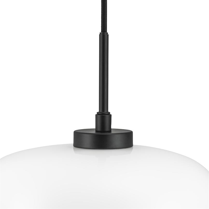 A white, round glass pendant hangs from a black fabric-covered cable; a black metal rod and round metal cap connects the screen to the ceiling against a neutral white background.