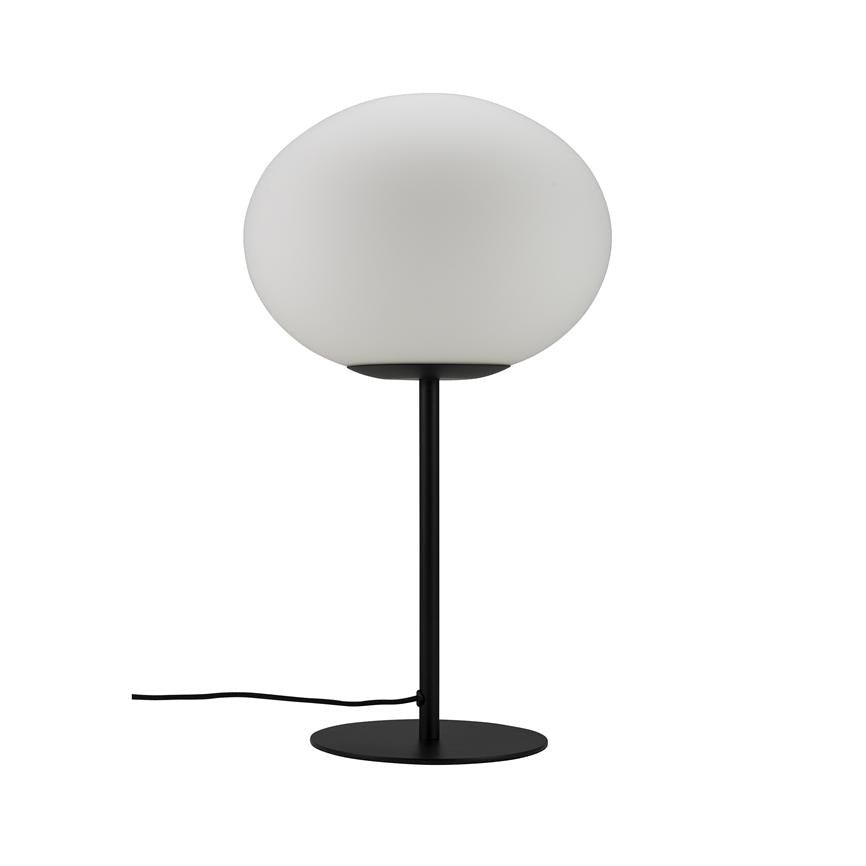 A table lamp with a round, matte white glass dome rests on a thin black rod, mounted on a flat round black base; a black wire lies on a white background.