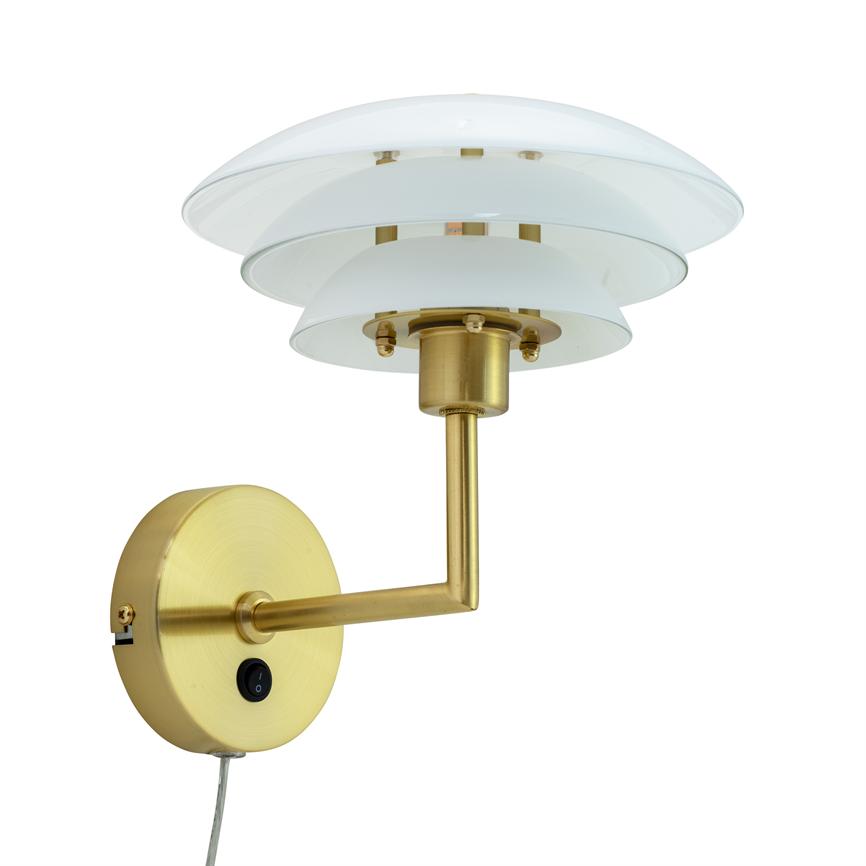 Wall lamp in brushed brass with three white, bowl-shaped glass shades; mounted on round wall base, arm bends 90°, on/off button marked "O", neutral white background.
