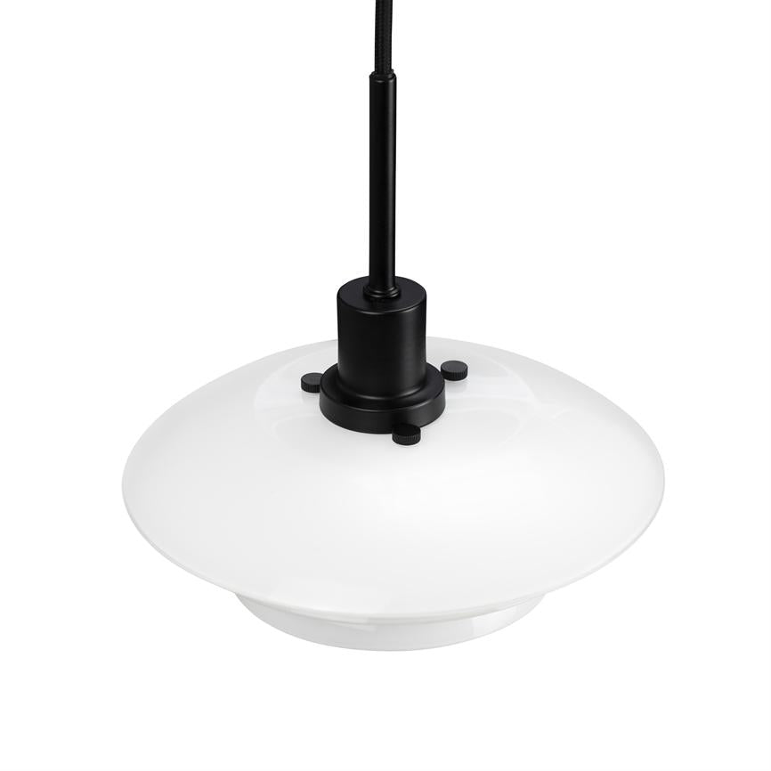 White round pendant- lamp hangs from a black cloth-covered cable; black metal socket secures the glass cup with three small screws, against a uniform white background.