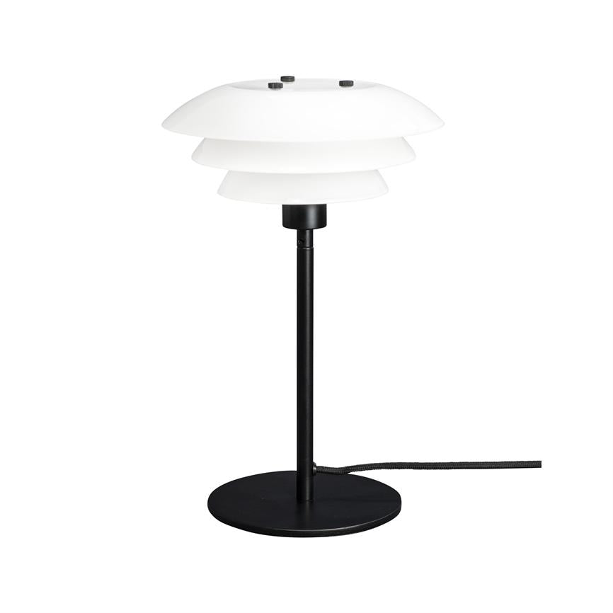 Table lamp with white layered shade, mounted on slim black rod; stands on a round black base and has a visible black textile cord against a white background.