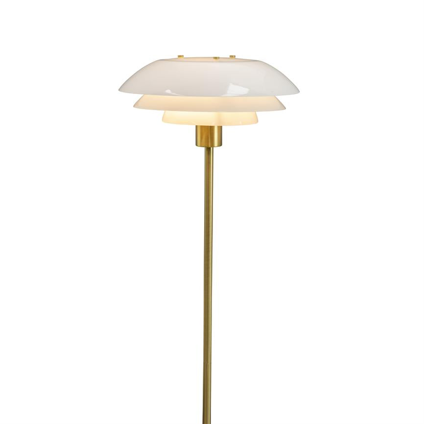 Floor lamp with three-layer white shades, emits soft, warm light; slim, matte brass rod and foot stand upright against a clean, white background.