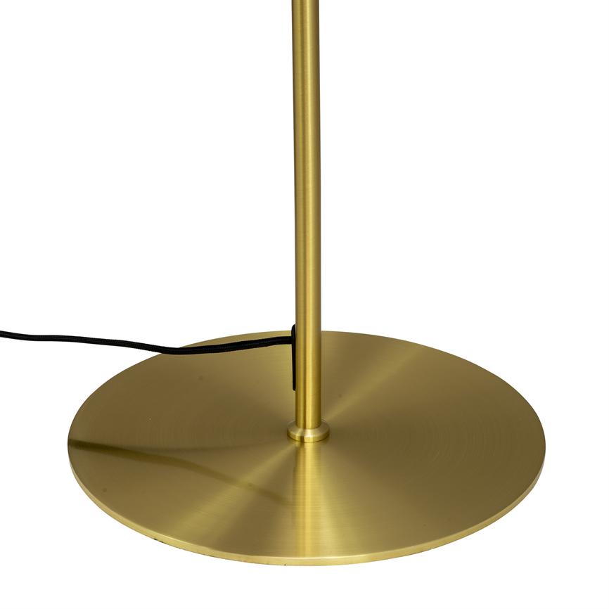 Gold-colored lamp stand stands upright on a flat, round brass-colored base plate; a black wire runs across the base against a uniform white background.