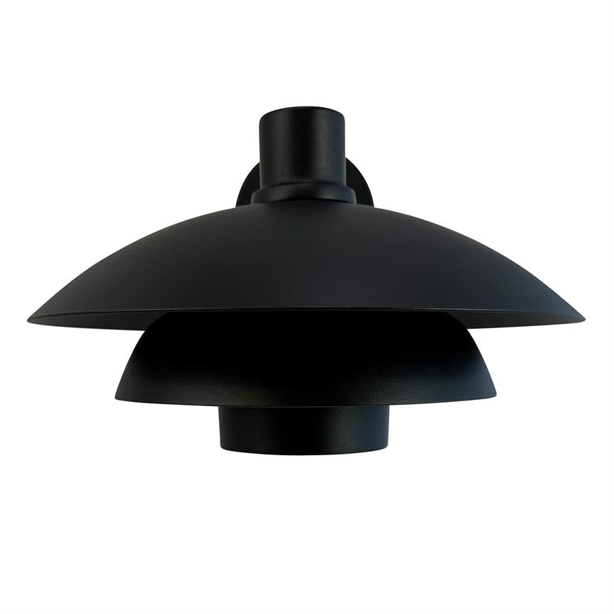 Black pendant lamp with three superimposed, conical shades hangs from ceiling suspension; the design focuses and diffuses light downwards in a white, neutral space.