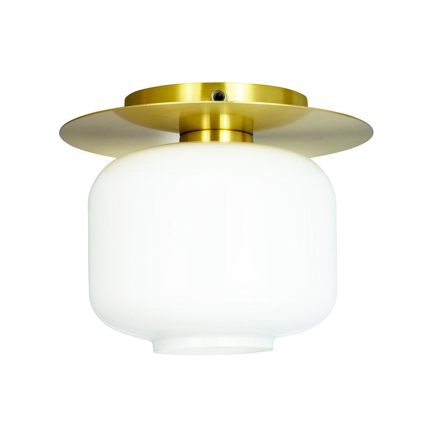 Ceiling lamp in opal white glass, smooth rounded globe shape, with round gold colored metal plate; mounted close to the ceiling, intended to spread soft, diffused light in a room.