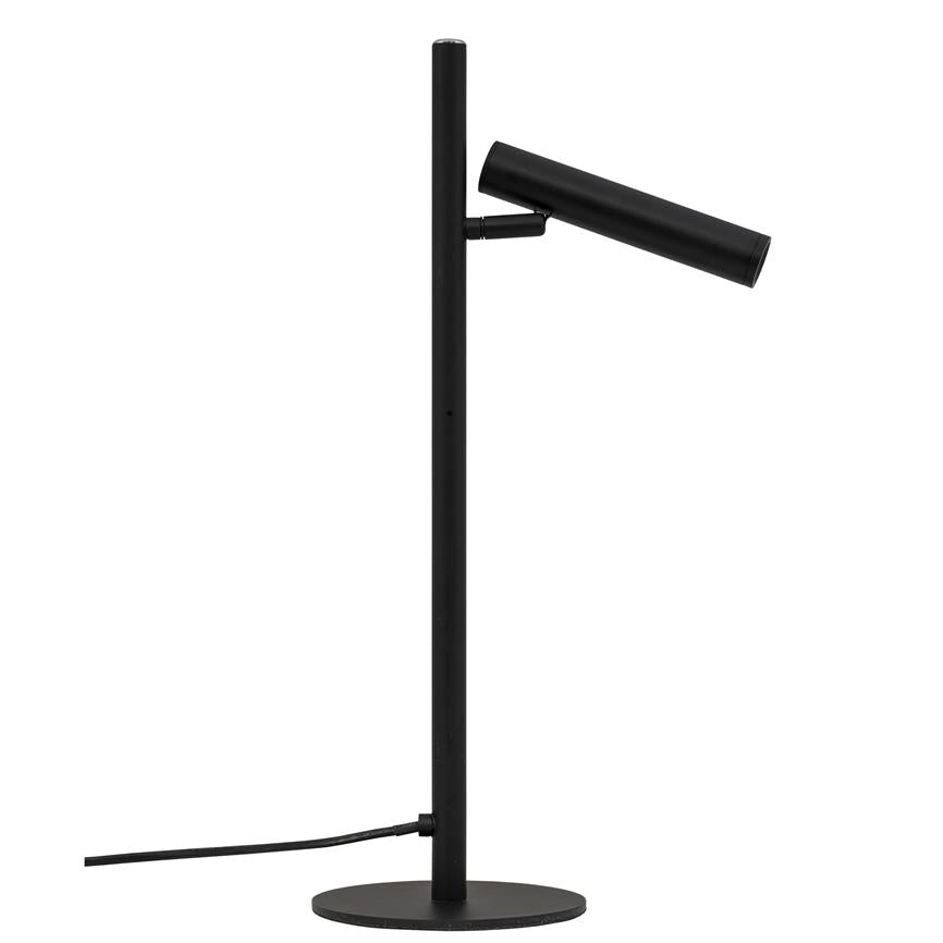 Black metal table lamp, cylindrical lamp head tilted diagonally downwards from a vertical pole; stands on round base with visible cord, placed against pure white background.
