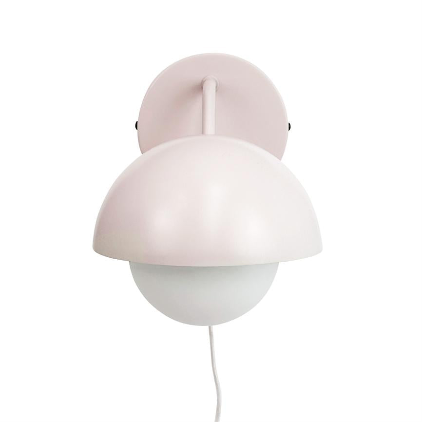 Wall lamp with light pink hemispherical metal shade over a round opal glass dome, mounted on a round wall bracket; white wire hangs down vertically.
