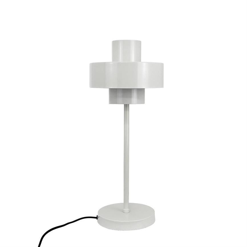 White table lamp stands on a round base; a slender metal rod leads up to a two-tiered cylindrical screen. The lamp is placed against a uniform white background, with a black cord on the left.