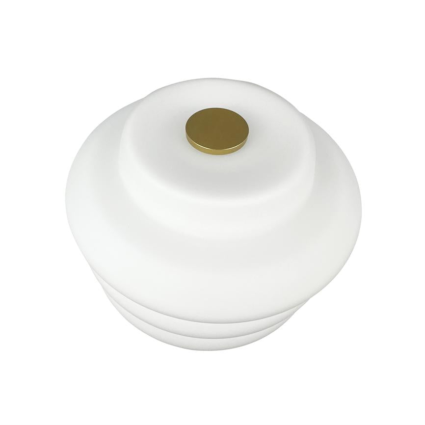 A white, tiered lampshade, viewed from above, rests centrally with a small round brass knob at the top and is presented against a uniform white background.
