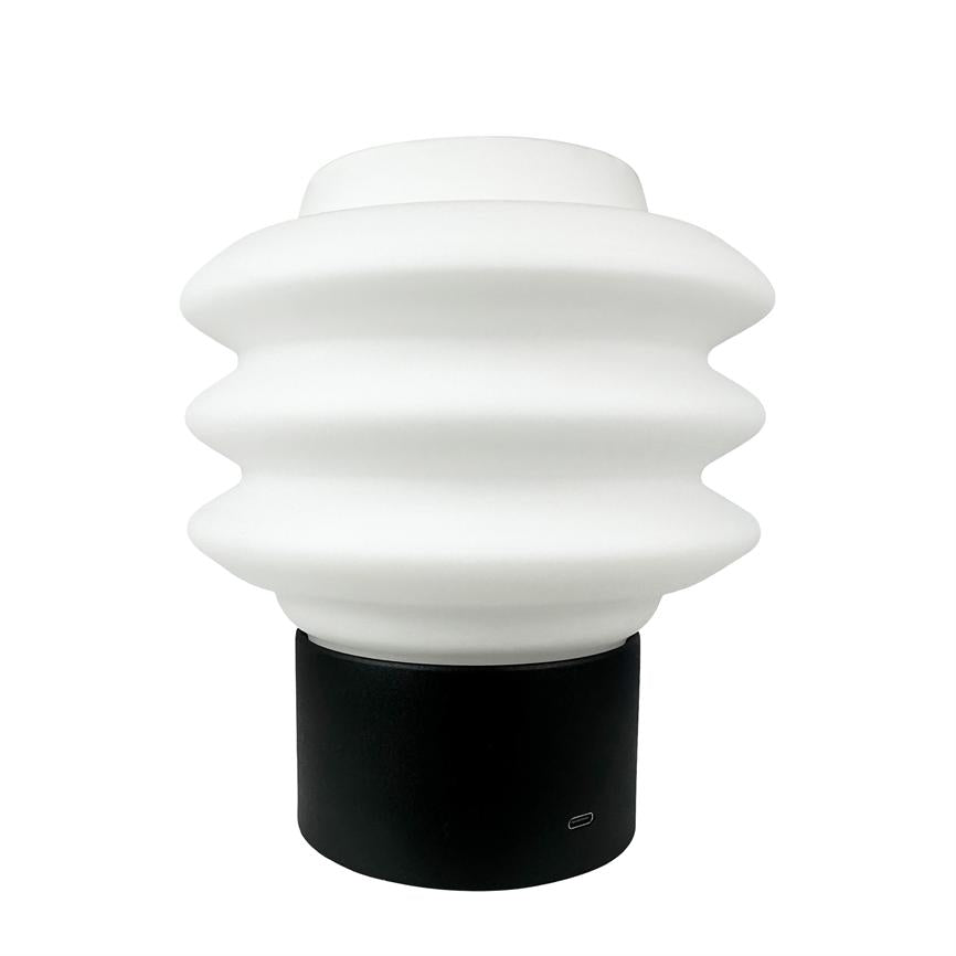 Wave-shaped white lamp sits on a black cylindrical base in front of a neutral white background. Text/icon at the base: "USB‑C".